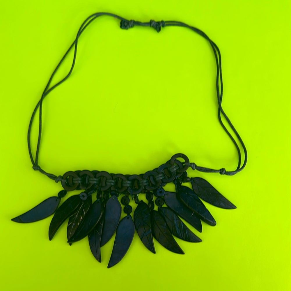 Feather like necklace,material unknown perhaps light wood or acrylic,dark mauve